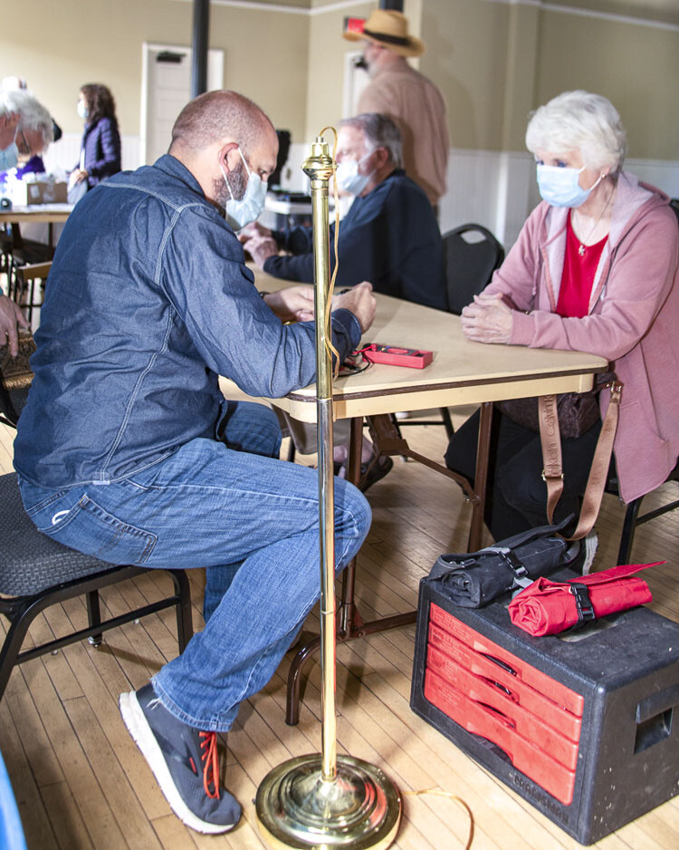 A volunteer fixer repairing a lamp for a client at a Repair Clark County event. Photo courtesy Paul Peloquin