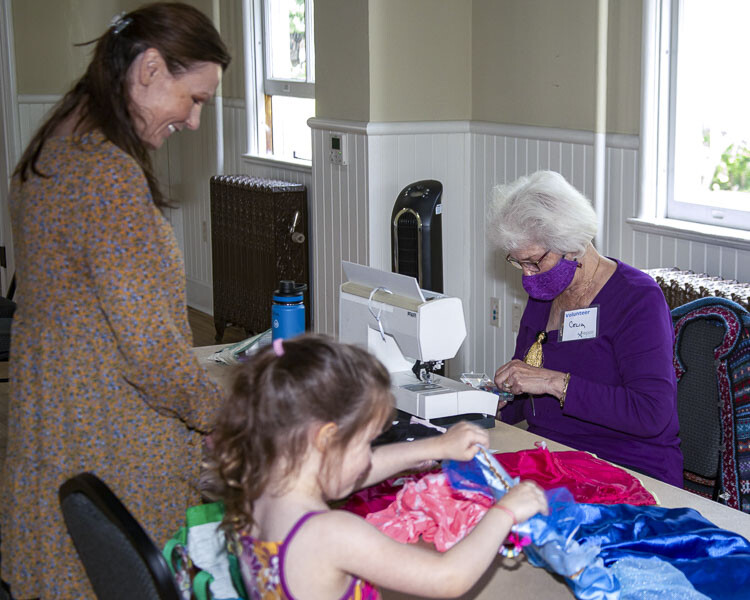 Volunteer fixer Celia C. helps give extended life to some worn out children’s clothing at a 2022 Repair Clark County event. Photo courtesy Paul Peloquin
