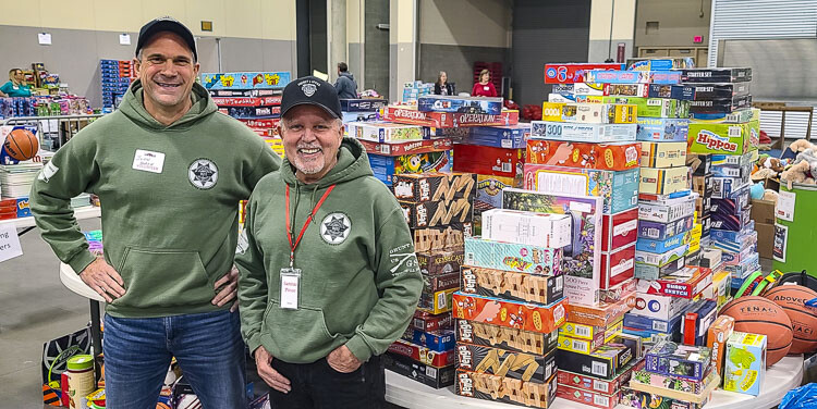 Sheriff-elect John Horch and Clark County Sheriff Chuck Atkins are proud to be part of Santa’s Posse, an organization that partners the sheriff’s office with the community to bring toys and food to families in need every Christmas season. Photo by Paul Valencia