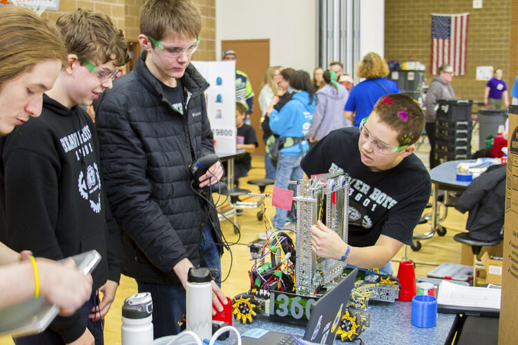 Team members rework and retool their robot after competing in a match. Photo courtesy Woodland School District