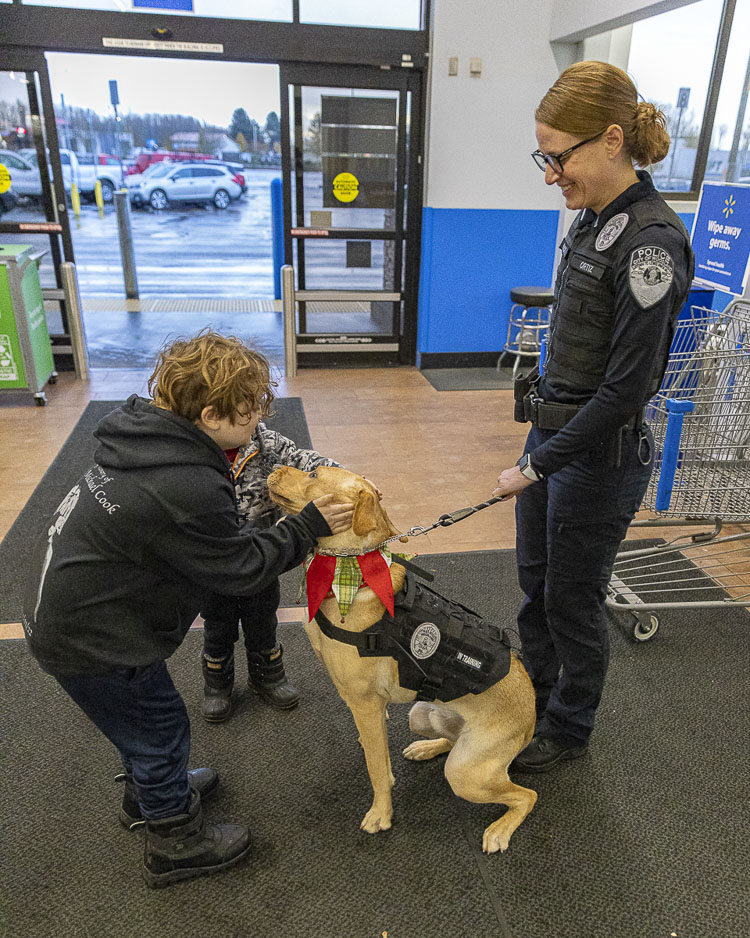 Children are shown here petting Bolo, the Woodland Police Department K9 officer, along with Woodland Police Department Lt. Jennifer Ortiz. Photo by Mike Schultz