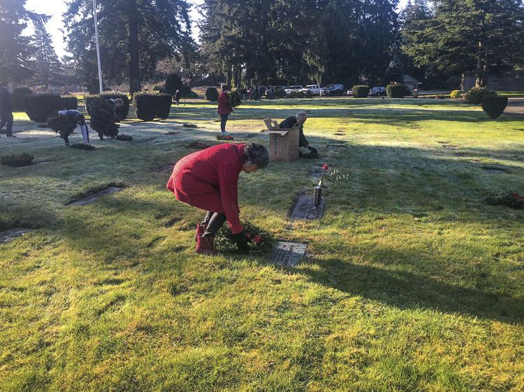 Sen. Lynda Wilson places a wreath on a gravesite Saturday during the Wreaths Across America event at Evergreen Memorial Gardens. Photo by Andi Schwartz