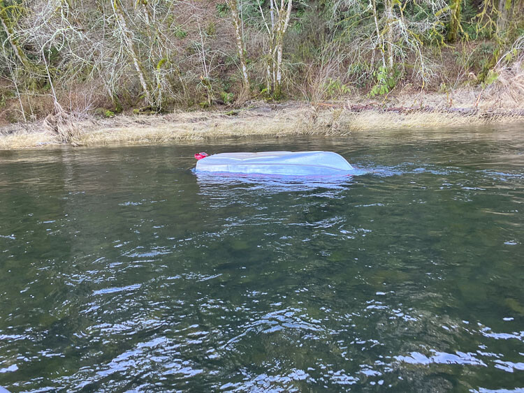 One man was rescued and another is still missing after the boat they were in capsized on the North Fork of the Lewis River Sunday afternoon. Photo courtesy Clark County Sheriff’s Office