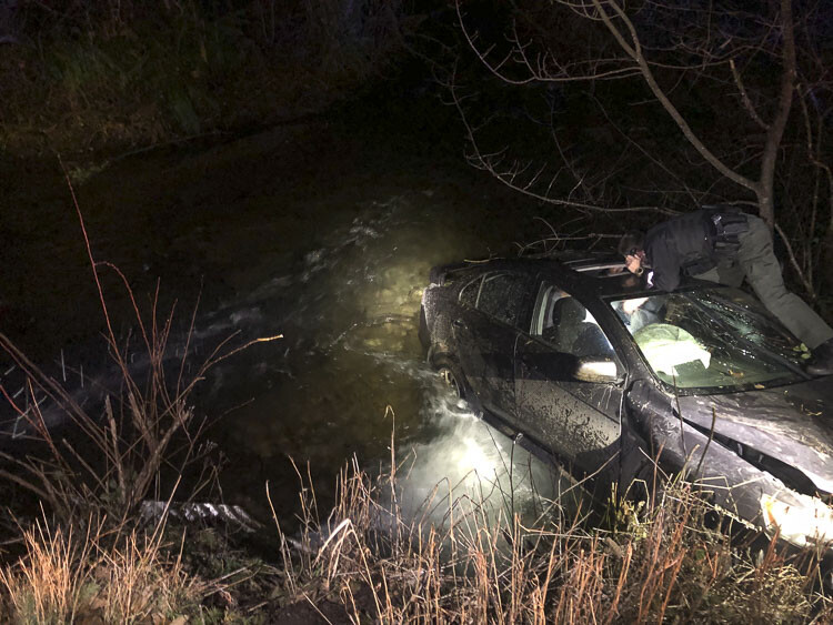 A preliminary investigation showed there had been four occupants in the vehicle when it was traveling west on NE Boulder Creek Rd before leaving the roadway and entering Boulder Creek. Photo courtesy Clark County Sheriff’s Office