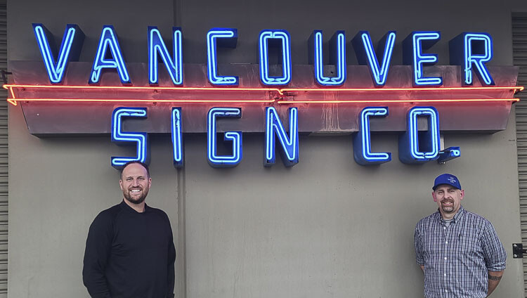 Andy Miller, left, is the new owner of Vancouver Sign Company. Adam Wallis, right, has worked with the company for 25 years and is also the company’s historian. Vancouver Sign Company is celebrating 100 years in business this year. Photo by Paul Valencia