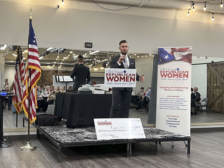 Andrey Ivanov, founder of Flash Love, accepts the Impact Award at the Clark County Republican Women quarterly dinner meeting Friday. Photo courtesy Bonnie Ruiz