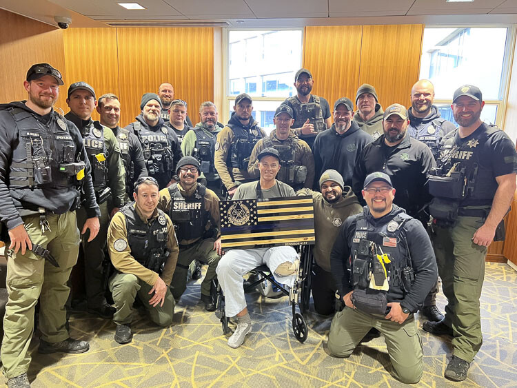 Clark County Sheriff’s Deputy Drew Kennison was presented with a custom flag that includes the team logo by his regional SWAT team Wednesday. Photo courtesy Clark County Sheriff’s Office