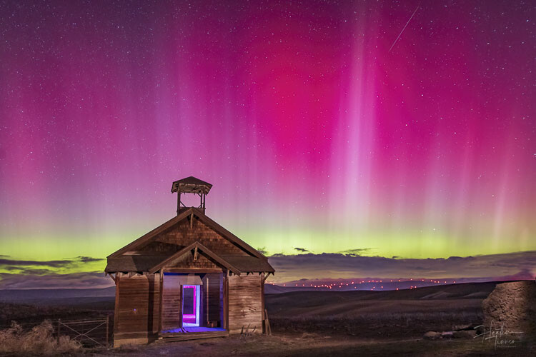 Another shot of the Northern Lights, the old Douglas school house, and, off in the distance, the red lights atop windmills. Photo by Heather Tianen
