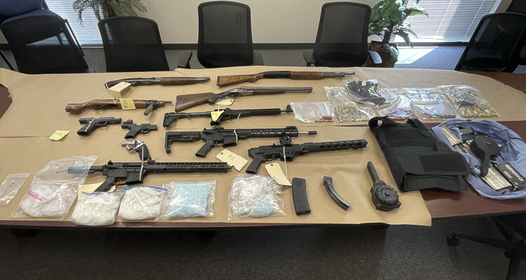 During the search warrant, 11 unlawfully possessed firearms including 1 reported stolen rifle, 2 sawed off shotguns and 1 sawed off rifle, over 2 pounds of methamphetamine, approximately 5,000 fentanyl pills, cocaine, crack cocaine, body armor, documents related to fraud and other items of evidence related to the investigation were recovered. Photo courtesy Vancouver Police Department