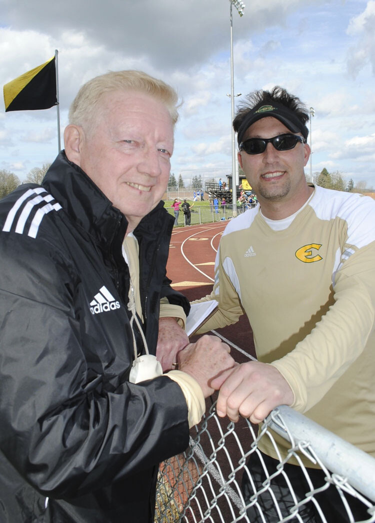 Gene Moore, left, was always helping his son, Steve, with coaching. Steve, shown here coaching at Evergreen, is now the Union track and field coach. Gene Moore helped out last season with the Titans. Gene died on Sunday. Photo courtesy Moore family