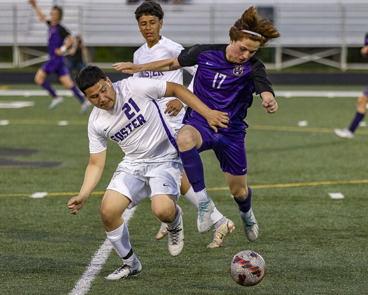 Columbia River’s Ryland Perron (17) battles with Foster’s Enrique Castellanos during their state playoff match Wednesday. Photo by Mike Schultz