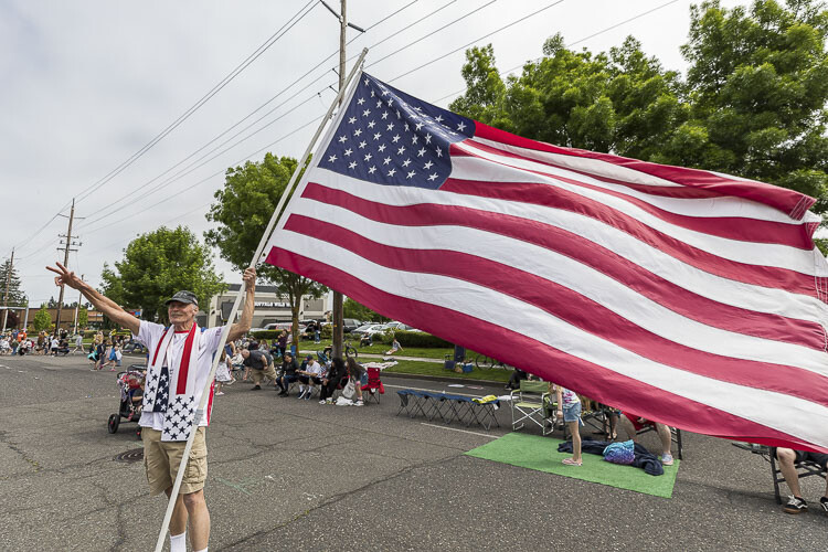 Participant James Saint waves his American flag at Saturday’s event. Photo by Mike Schultz
