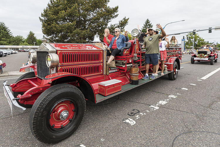The Streissguth Family shows off their antique fire truck. Photo by Mike Schultz