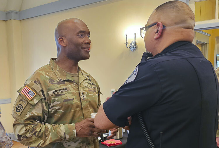 Lt. Gen. Xavier T. Brunson, commander of Joint Base Lewis-McChord, talks with Troy Price, assistant chief of police for Vancouver. Brunson visited Vancouver Barracks on Friday, then visited with dozens of business leaders, as well as city and county leaders. Photo by Paul Valencia