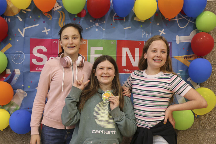 Shown here (left to right) are Olivia Nichol, Charlene Foote, and Haylee Hardin as they pose in front of the event backdrop. Photo courtesy Washougal School District