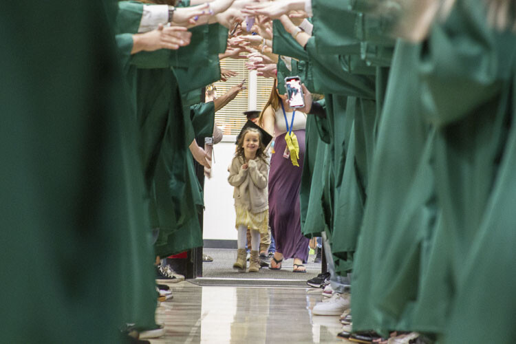 WHS grads formed a Graduation Tunnel for each elementary's kindergartners students to celebrate their transition to 1st grade. Photo courtesy Woodland School District