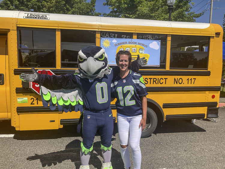 Blitz from the Seattle Seahawks showed up last week to celebrate the achievement of Jenn Scott of Camas Public Schools. Scott has organized a mobile library that goes to elementary school during the summer months. The Seahawks and Premera Blue Cross named Scott one of the “Heroes of the Classroom” in Washington. Photo courtesy Premera Blue Cross