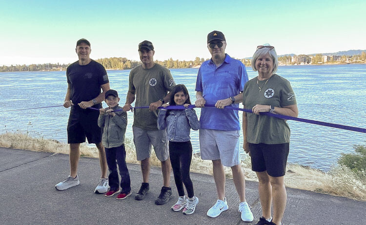Vancouver Police Officer Jeff Anaya (third from left) and Jim Mains (second from right) and Jodi Sharp (far right) join a pair of young enthusiasts in holding the blue ribbon to honor fallen CCSO Sgt. Jeremy Brown. Photo courtesy Leah Anaya