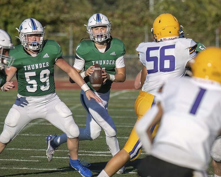 Mountain View quarterback Cash Cook looks for an open receiver, while being protected by right guard Joseph Burcham during their game Friday against Hanford. Photo by Mike Schultz