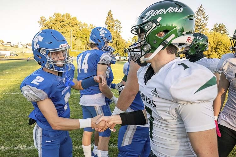 La Center’s Garrett Maunu shakes hands with the Woodland Beavers before their game Friday night. Maunu is one of four seniors on La Center’s team that has been with the program since they started in high school. Photo by Mike Schultz