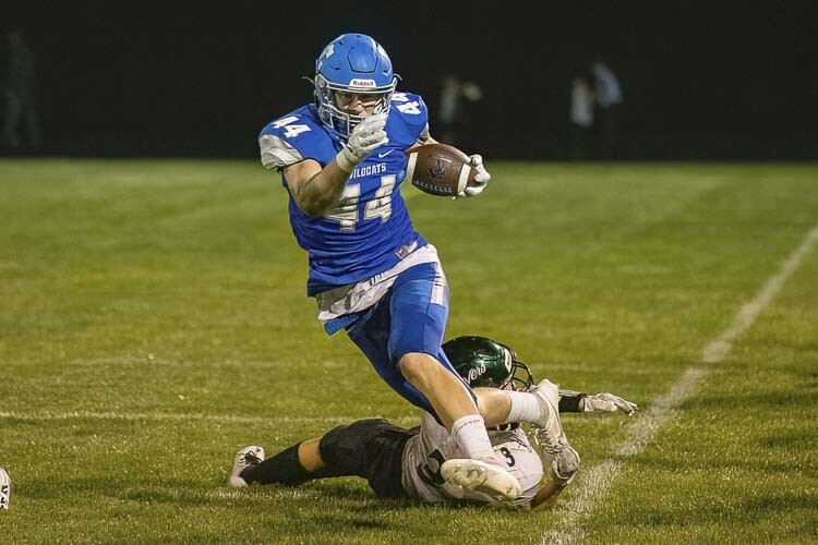 Austin Nixon, one of four senior leaders for La Center, stays in bounds to pick up a few more yards against Woodland on Friday. Photo by Mike Schultz