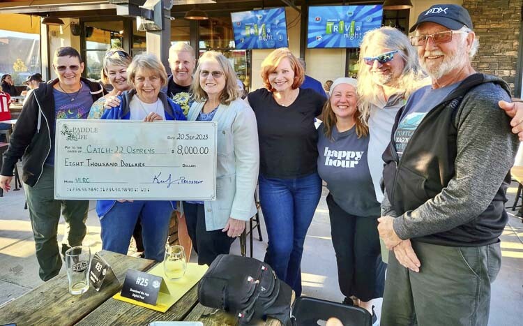 On Wednesday, the dragon boat charity organization Paddle For Life presented the Catch-22 Breast Cancer Survivors Dragon Boat Team with a $8,000 check from the boat race fundraiser held in Ridgefield last month. Photo courtesy Catch-22 Breast Cancer Survivors Dragon Boat Team