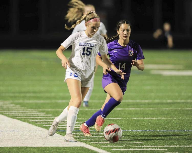 Ridgefield’s Victoria Lasch (15) controls the ball past Columbia River’s Naomi Axelrod (14) in the first half of the Spudders’ 1-0 loss. Photo courtesy Chris Barker
