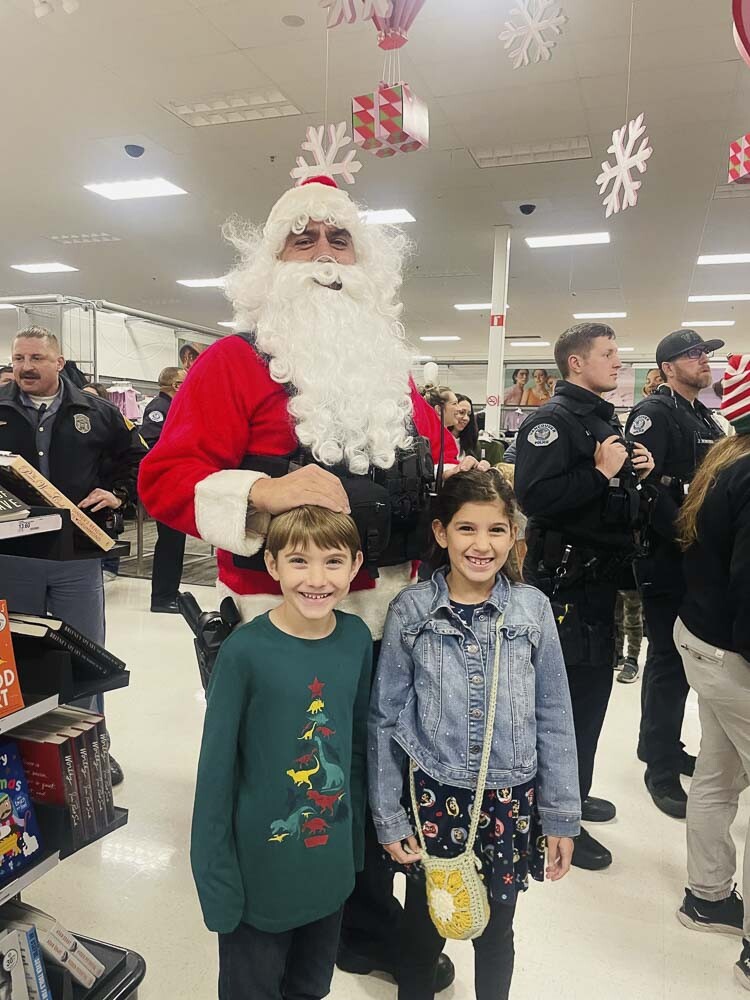 Santa (Officer Clesson Werner) is shown here with a couple of Santa’s helpers. Photo courtesy Leah Anaya