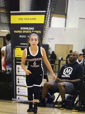 An action shot of Ava Smith, then an eighth-grader with the Tree of Hope club team, with Kobe Bryant in the background, who was coaching his daughter’s team. Photo courtesy Smith family