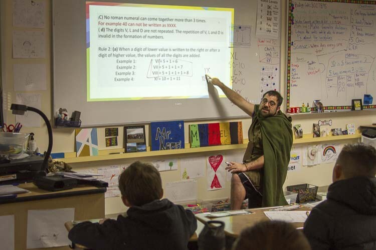 Matthew Kamel taught students how to perform mathematics using Roman numerals in the style of the Middle Ages. Photo courtesy Woodland School District