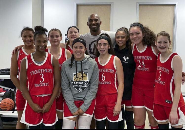 Ava Smith, No. 6, and her Tree of Hope teammates pose with Kobe Bryant for a picture back when Ava was in eighth grade. Now a senior at Union High School, Smith is reflecting on what it was like to play against Kobe’s daughter, Gigi, in her last game before a helicopter crash took the lives of Kobe, Gigi, and seven others. Photo courtesy Smith family