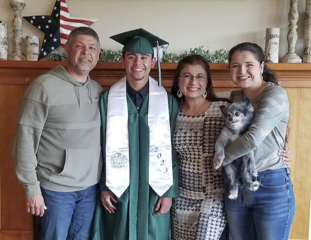 Asha Riley is shown here with husband Dave Riley (far left), son DJ Riley (left), daughter Leah Riley (right) and Tucker Riley (dog). Photo courtesy Woodland School District