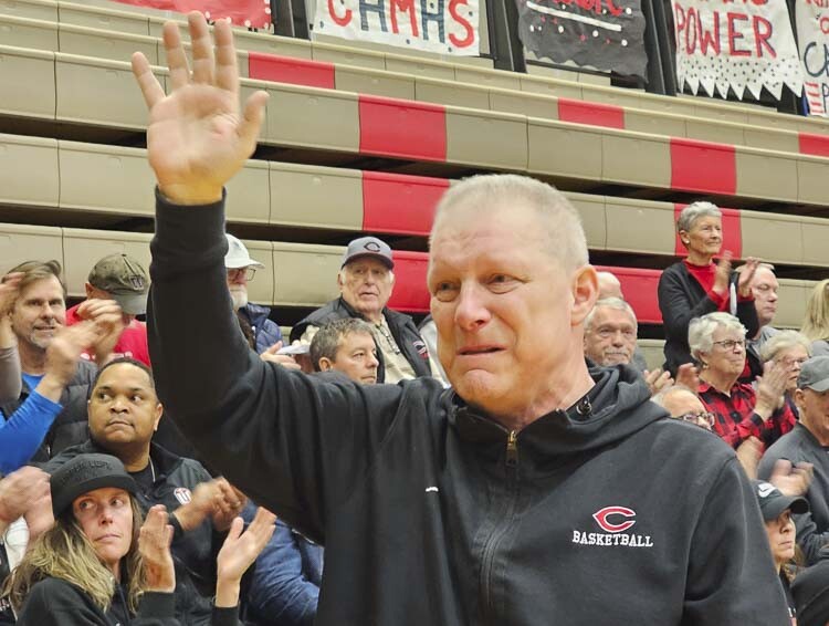 Camas girls basketball assistant coach John Griffin waves to the crowd Friday. He was recognized during Camas’ Block Cancer Night, with the crowd supporting Griffin’s battle with cancer. Photo by Paul Valencia