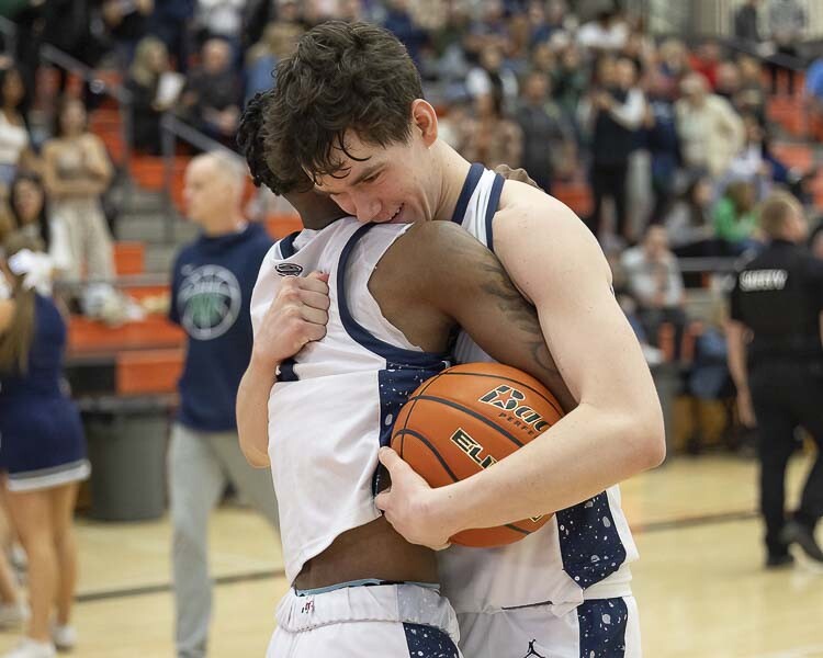 Gavin Perdue (right) celebrates with Demaree Collins on Saturday after the Skyview Storm clinched a trip to Tacoma for the Class 4A round of 12 in the state tournament. Photo by Mike Schultz
