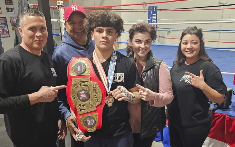 The Elizondo family (middle) trains at Young Guns Boxing, which is run by former professional boxer Jason Davis (left) and his wife Jess (right). Cain Elizondo Jr. has won two national championships in 2024 and on Friday, he was officially ranked No. 1 in the country by USA Boxing. Photo by Paul Valencia