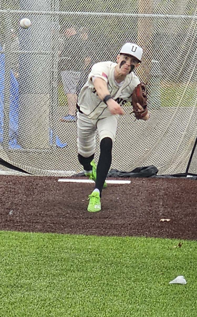 Mitch Ratigan, a senior at Union High School, warmed up in the bullpen on April 11, prior to his return to the baseball field for the first time since tearing his ACL in his right knee during football season. Photo by Paul Valencia