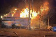 Outbuilding and travel trailer destroyed in fire