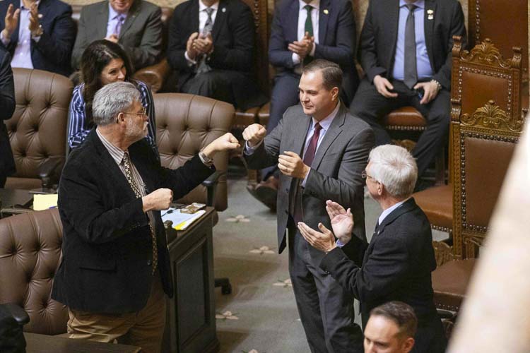 Senate Minority Leader John Braun (center), R-Centralia, fist bumps Rep. Ed Orcutt (left), R-Kalama after being acknowledged during Gov. Bob Ferguson’s inaugural address Wednesday, Jan. 15, 2025, at the Washington State Capitol in Olympia. Rep. John Ley is shown on the left. Photo courtesy Ryan Berry/Washington State Standard