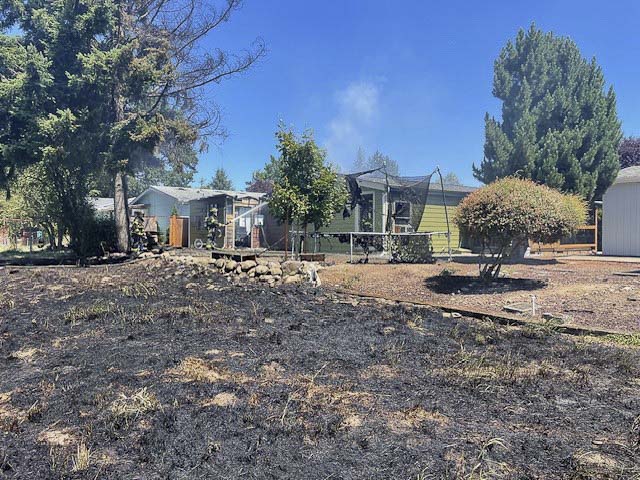 Vancouver Fire crews contained two burning homes and a brush fire in Oak Creek Mobile Home Park; five residents were displaced, no injuries reported.