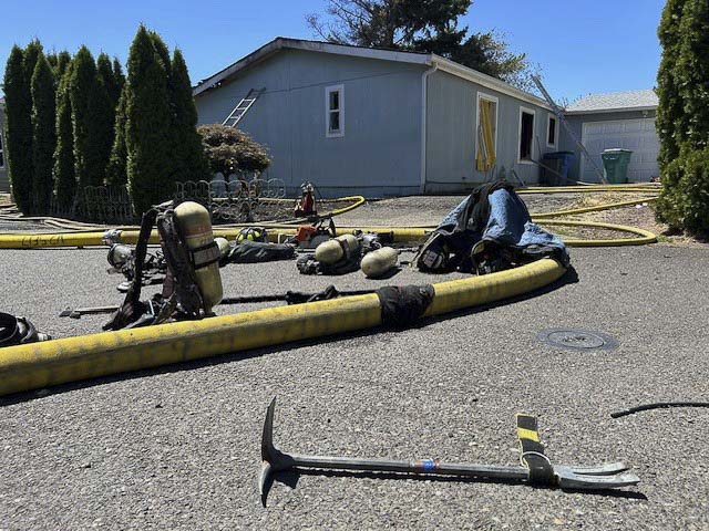 Vancouver Fire crews contained two burning homes and a brush fire in Oak Creek Mobile Home Park; five residents were displaced, no injuries reported.