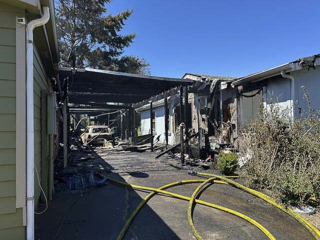 Vancouver Fire crews contained two burning homes and a brush fire in Oak Creek Mobile Home Park; five residents were displaced, no injuries reported.