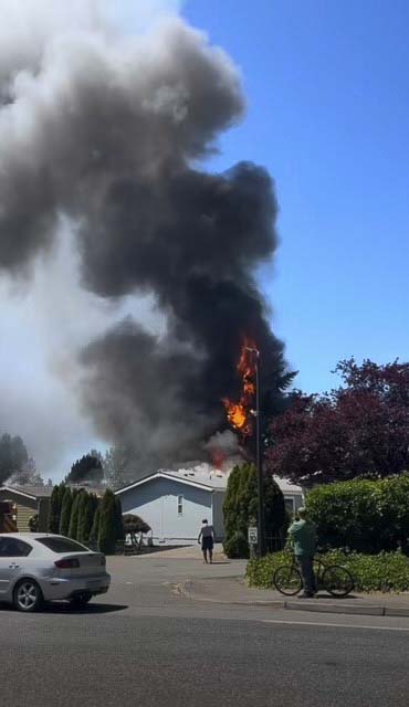 Vancouver Fire crews contained two burning homes and a brush fire in Oak Creek Mobile Home Park; five residents were displaced, no injuries reported.