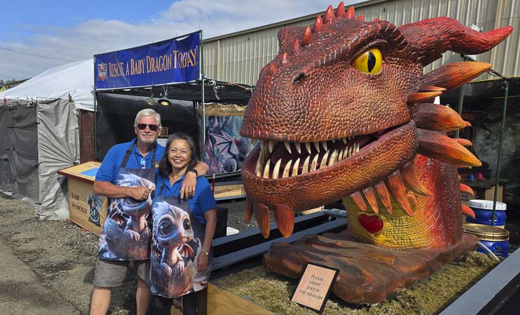Peter and Lisa Noah of Vancouver are proud to have created this new vendor/entertainment/attraction at the Clark County Fair. Families are encouraged to rescue a baby dragon. Photo by Paul Valencia