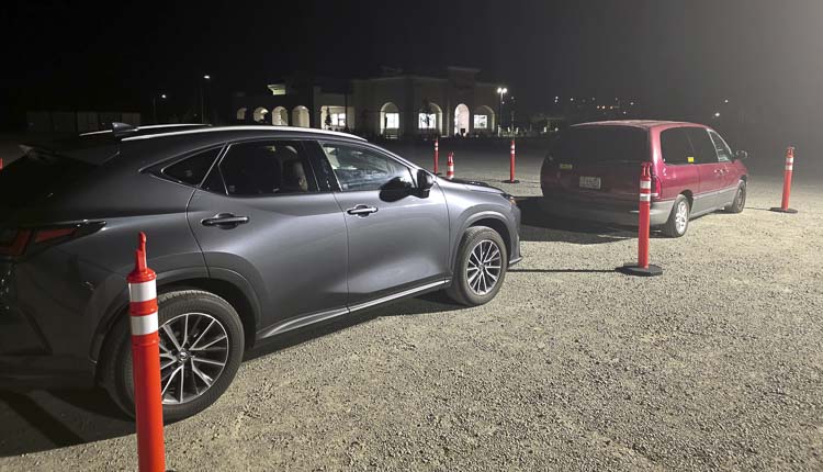 The In-N-Out Burger restaurant did not have its exterior lights on at 1 a.m. Wednesday, but there were spotlights to help security queue the line of cars that were forming for the restaurant's opening. Photo by Paul Valencia