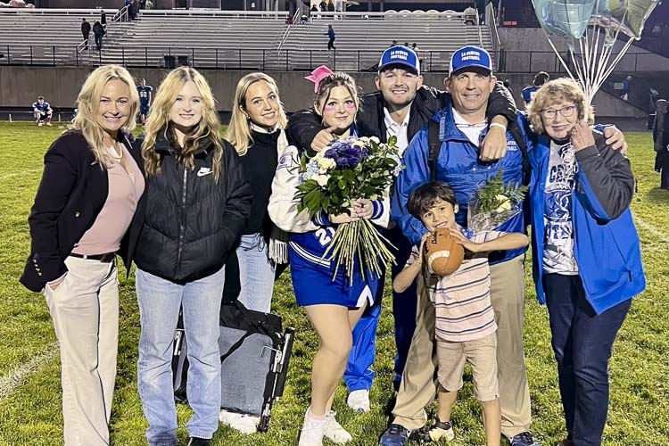 The Lambert children have grown up or are still growing up with La Center football. John has been the head coach since 1999 and Kerry has embraced being a coach’s wife as the team’s videographer. From left to right: Kerry, Jane, Mary, Lynda, Tom, John, Lynda Studebacker, and Scotty with the football. Photo courtesy Lambert family