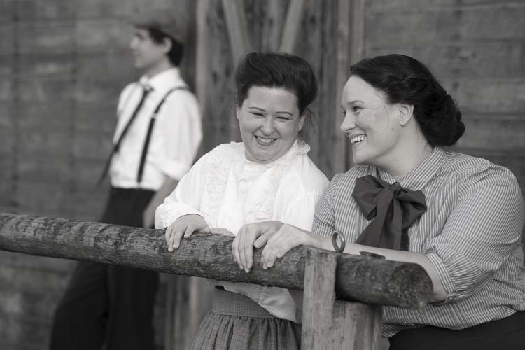 Best friends Essie (Laura Henderson) and Kit (Katie Norcross) share a laugh as Jamie (Cody Swires) contemplates his scheme to procure the Garner land. The world premiere of “There’s Still Snow on Silver Lake” is Sept. 12 through Oct. 5 at the Love Street Playhouse in Woodland. Photo by Bobby Pallotta