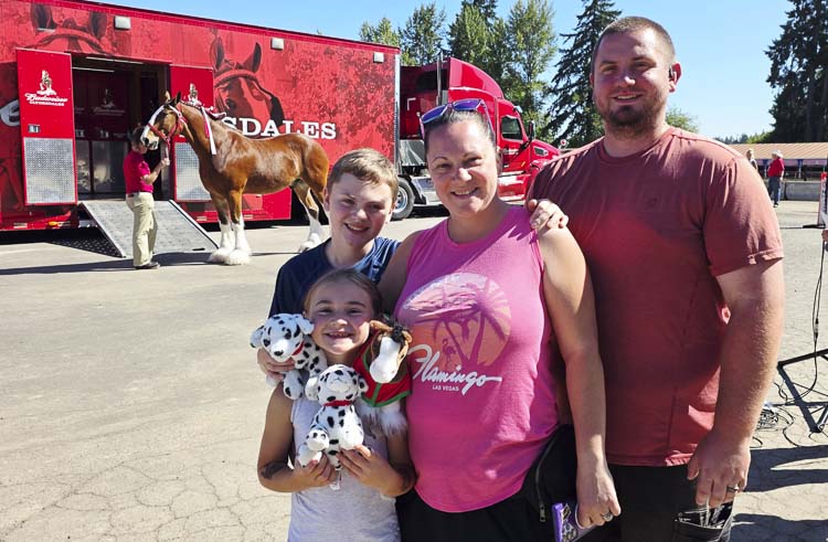 The Collins family from Troutdale, Ore — Railea, Alec, and their children Logan and Addison — came to the fair to enjoy a number of attractions. But the top priority for the family was to see the Clydesdales. Photo by Paul Valencia