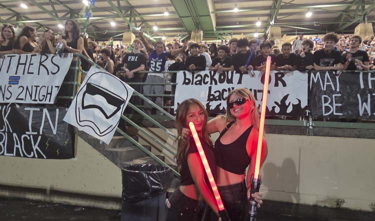 Alexis Diaz, left, and Talley Pope, students at Mountain View, were instrumental in getting a huge student section out to McKenzie Stadium on Thursday. Mountain View is not yet in session, due to a strike by employees, but the student leaders still wanted to show school spirit at the first high school football game of the season. Photo by Paul Valencia