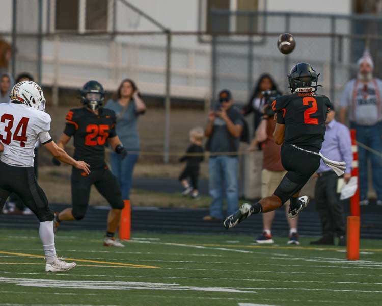 Battle Ground quarterback Ethan Adams jumps while firing the perfect pass to Thomas Avery (25) for a touchdown pass Friday night against Prairie. Photo courtesy Chris Barker.