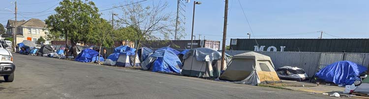 One side of the sidewalk is completely blocked by tents on West 12th Street in Vancouver. Photo by Paul Valencia